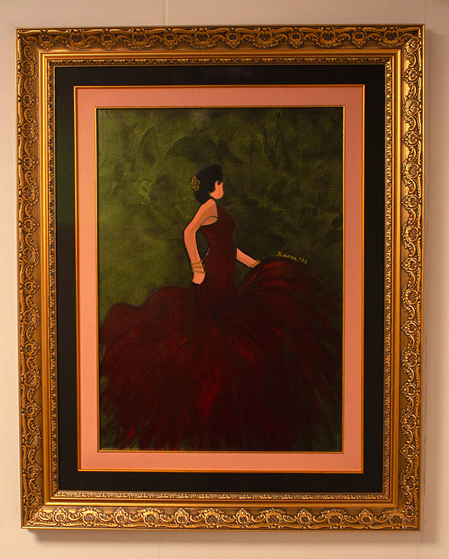 Oil painting of a flamenco dancer in a red dress in an ornate gold frame.